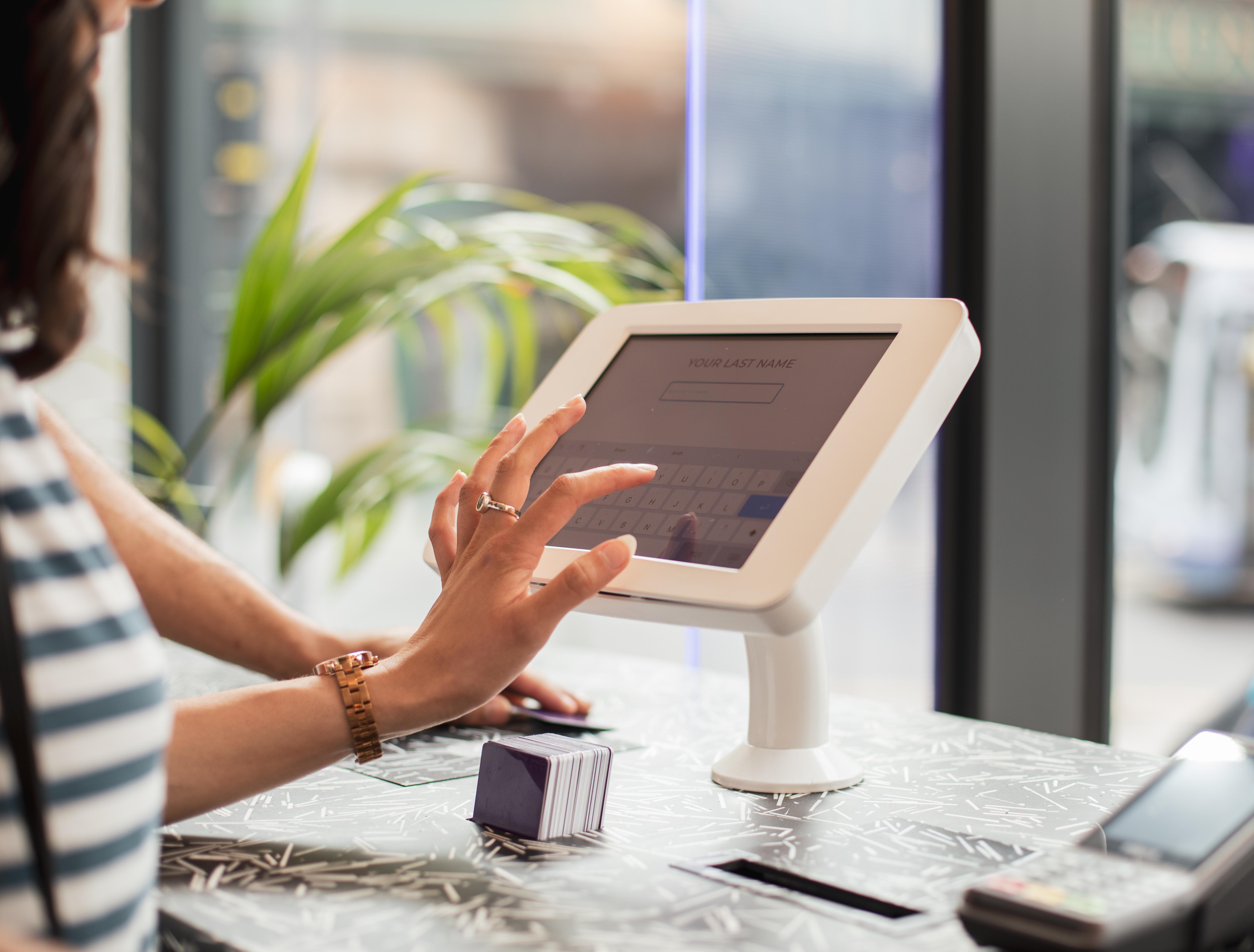 Yotel Глазго Екстер'єр фото A woman using a tablet to enter her name at a check-in desk